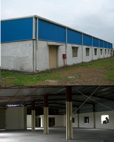 The image consists of two parts. The top section displays the exterior of a large warehouse or shed in talawade, pune with a blue corrugated metal upper section and a white concrete lower section. A single door and a red fire extinguisher box are visible on the exterior wall. The bottom section showcases the interior of the same building, which is spacious and empty, with multiple support columns and windows. The unfinished interior features exposed beams and a metal roof structure.